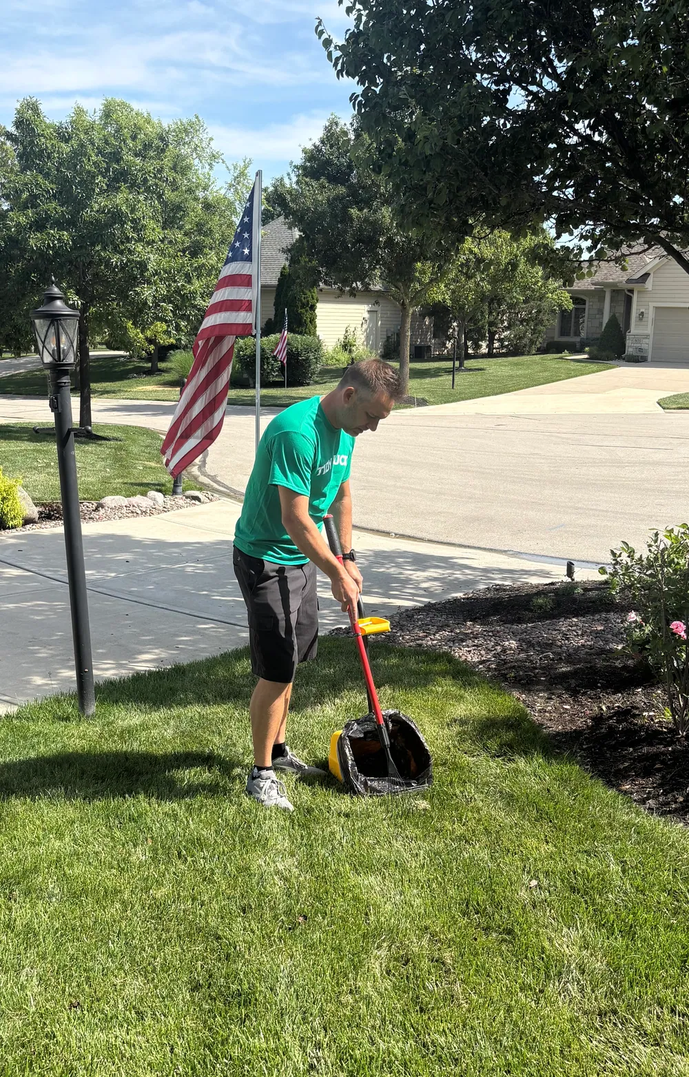 Tidy Tucker team member cleaning a front lawn
